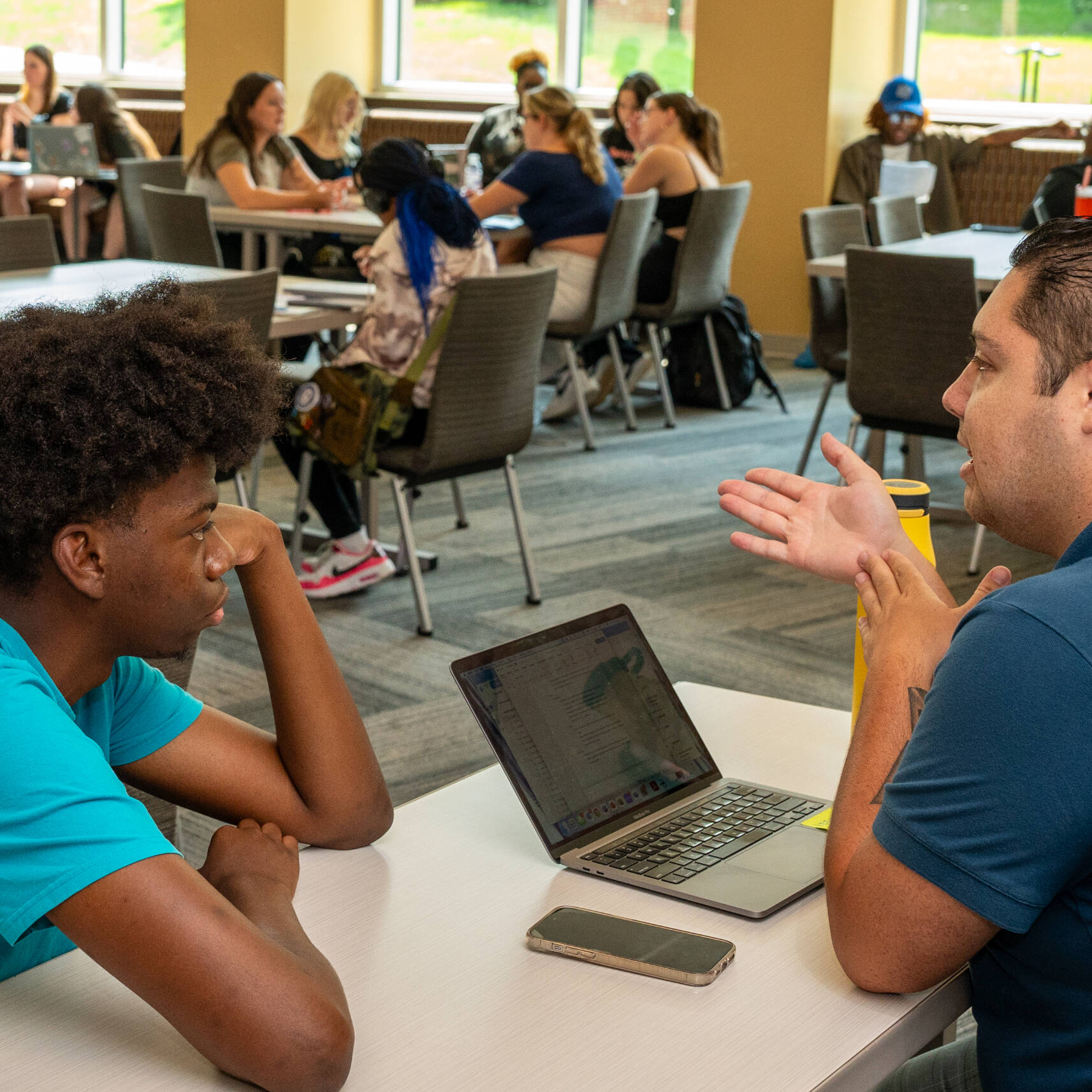GVSU photography student Roderick Clark, left, talks with student success coach Adrian Hall as part of the Oliver Wilson Scholars program at the Holton-Hooker Learning and Living Center on July 22.